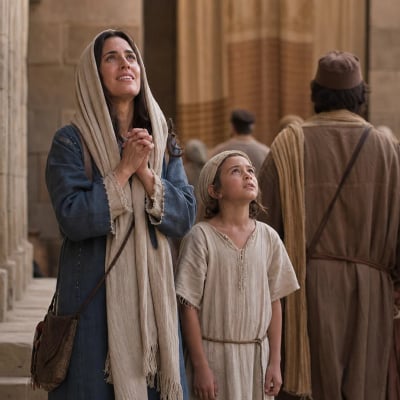 Hannah praying joyfully after dedicating Samuel at the temple, giving thanks to God who heard her prayer.