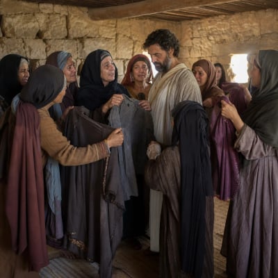Peter in the upper chamber at Joppa while grieving widows show the clothing Dorcas had sewn with her own hands.