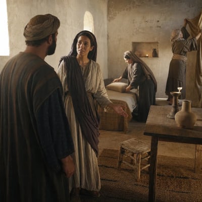 A woman of Sunam arranging a small chamber for the prophet Elisha with a bed, table, stool, and lamp.